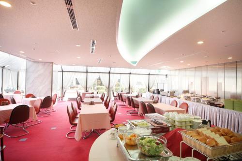 成田成田机场酒店的一间带桌椅的用餐室和一间自助餐厅