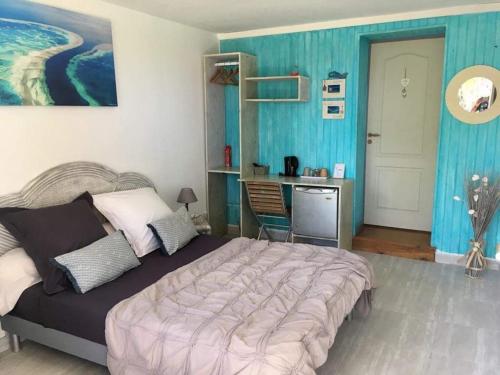 Bandrélé猴面包树住宿加早餐旅馆的一间卧室设有一张大床和蓝色的墙壁