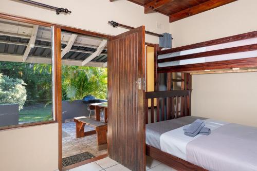 圣卢西亚Manzini Chalets的一间卧室设有一张床和一个大窗户