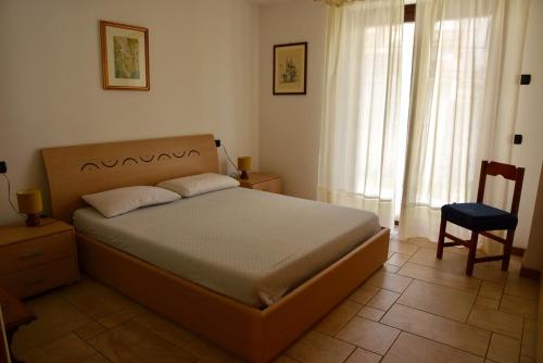 瓦尔迪登特罗Baitin Finferlo的卧室配有床、椅子和窗户。