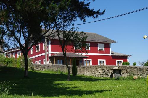 纳维亚苏琴乡村酒店的前面有石墙的红色房子