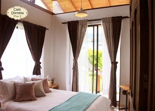 瓜杜阿斯Casa Dornella - Casa de Hospedaje的一间卧室设有一张床和一个大窗户