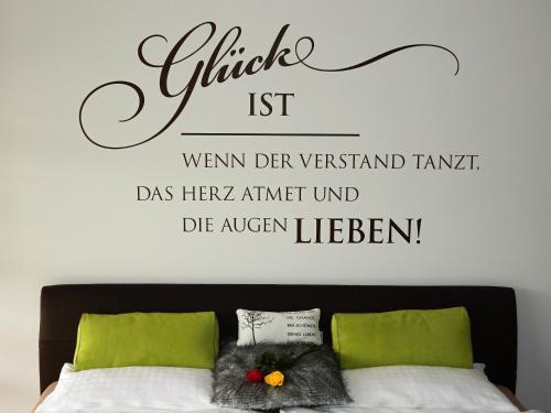 埃尔察赫WEITBLICK "entspannen - wohlfühlen - aktiv erholen"的卧室配有一张挂有墙上标志的床