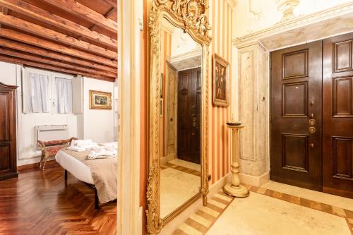 罗马Residenza Contessa Costanza的一间带镜子的卧室和一张位于客房内的床
