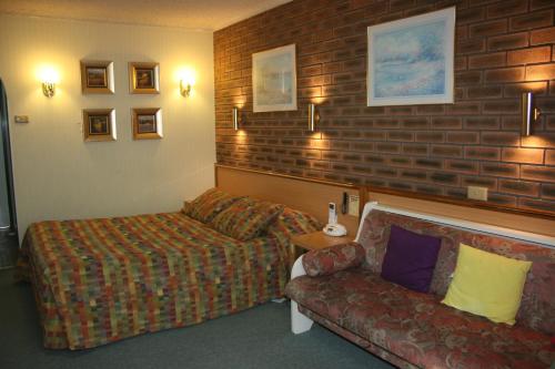 墨尔本Arden Motel的客厅配有沙发和椅子