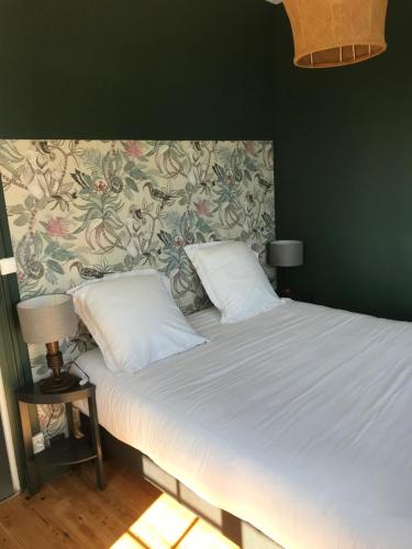滨海克里耶勒La Vague - Accès Piscine的卧室内的一张带两个枕头的床