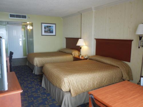 弗吉尼亚海滩海鹰汽车旅馆的酒店客房设有两张床和一张桌子。