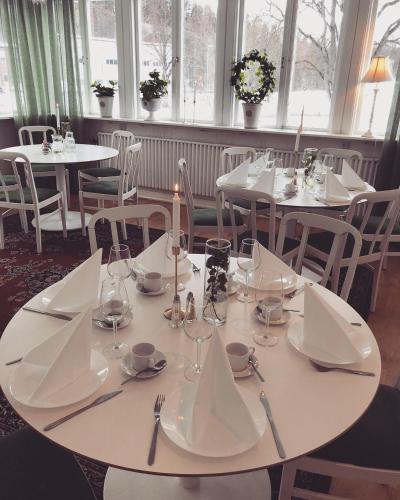 TabergHotell Taberg的餐厅配有白色桌椅