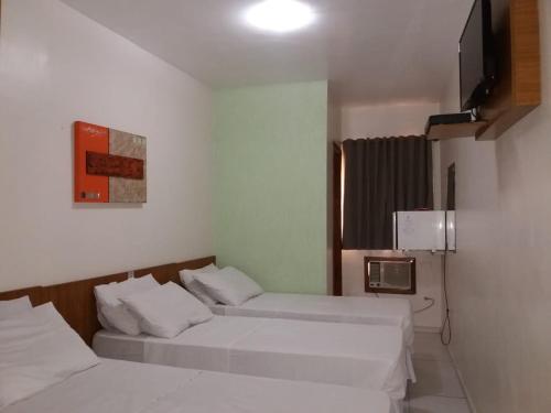 Ipê Guaru Hotel客房内的一张或多张床位