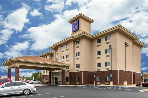 亨茨维尔Sleep Inn & Suites Huntsville near US Space & Rocket Center的一座酒店大楼,上面有一个钟