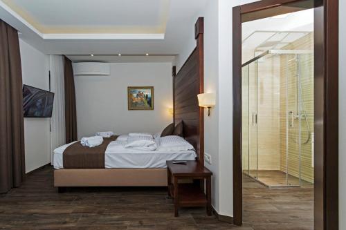 奥赫里德Villa Sofija的一间卧室设有一张床和一个步入式淋浴间。