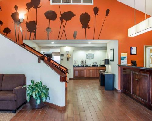 查尔斯顿Sleep Inn North Charleston Ashley Phosphate的大堂设有橙色墙壁、楼梯和厨房