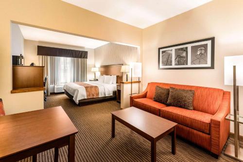 柯林斯堡Quality Inn & Suites University Fort Collins的酒店客房设有一张沙发和一张床