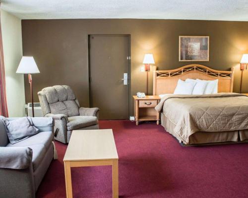 圣奥古斯丁海滩Quality Inn & Suites St Augustine Beach Area的酒店客房配有床、沙发和椅子