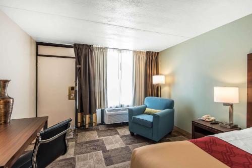 Oak Grove橡树林伊克诺山林小屋的酒店客房,配有一张床和一张蓝色椅子