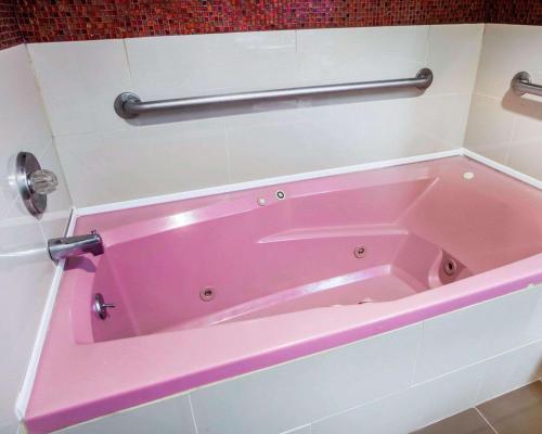 泽西市泽西城伊克诺旅店的浴室内设有一个粉红色的浴缸