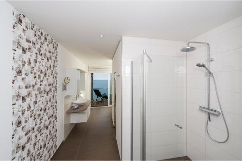 奥尔本尼兹Küstenküche的带淋浴和盥洗盆的白色浴室