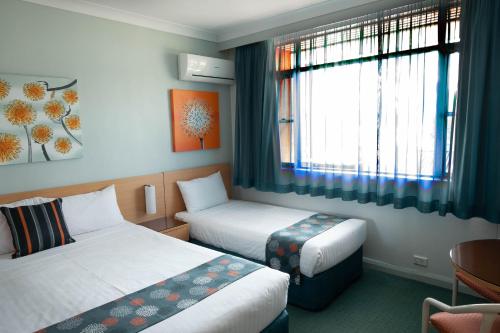 悉尼马奇特酒店的酒店客房设有两张床和窗户。