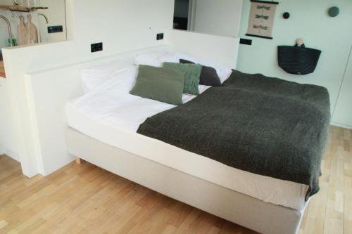 阿姆斯特丹Houseboat Studio Sooki的一张白色的大床,上面有灰色的毯子