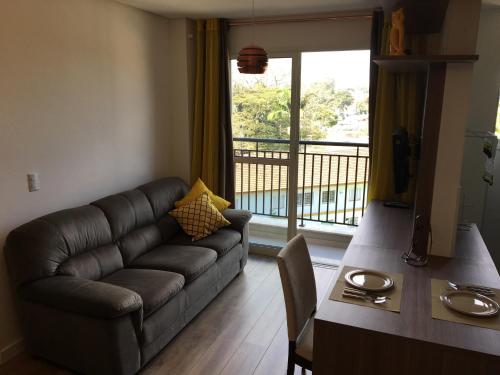 科蒂亚Apartamento novíssimo em Granja Viana的带沙发和桌子的客厅以及阳台。
