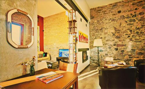 科洛尼亚-德尔萨克拉门托阶地精品酒店的客厅配有桌子和石墙