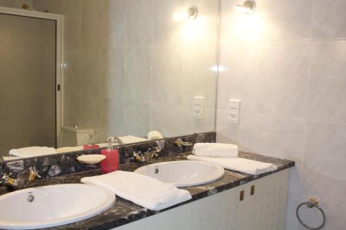 菲盖拉-达福什Casino Figueira Prime Apartment的一间带两个盥洗盆和大镜子的浴室