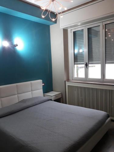 米兰Sira House Milano的一间卧室设有一张床和蓝色的墙壁