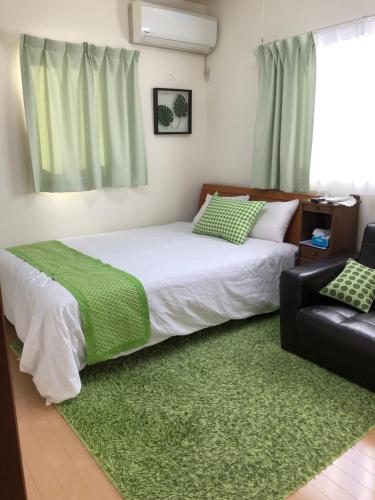 垂井町波萨达卡萨生态酒店的一间卧室配有床和绿色地毯