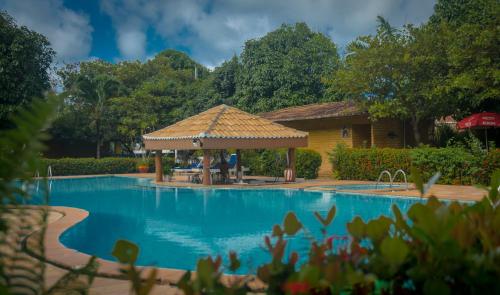 巴拉多库努Pousada do Forte的房屋旁带凉亭的游泳池