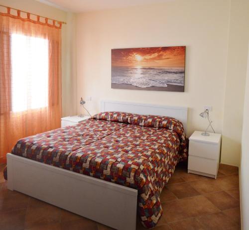 加利波利Tramonto -Appartamenti OltreMare- Lido Conchiglie Gallipoli的一间卧室配有床和2个床头柜