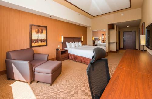莱维斯李维斯品质套房酒店的大型酒店客房,配有床和椅子