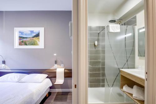 圣克洛德全景餐厅朱拉酒店的一间卧室配有一张床,浴室设有淋浴。