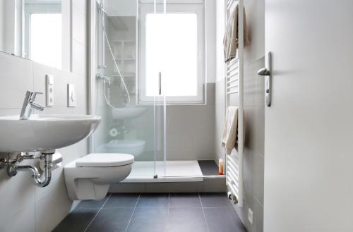 柏林SC 2 Cozy Family & Business Flair welcomes you - Rockchair Apartments的浴室配有卫生间、盥洗盆和淋浴。