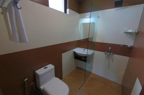 蒙纳Tea Castle Munnar的一间带卫生间和玻璃淋浴间的浴室