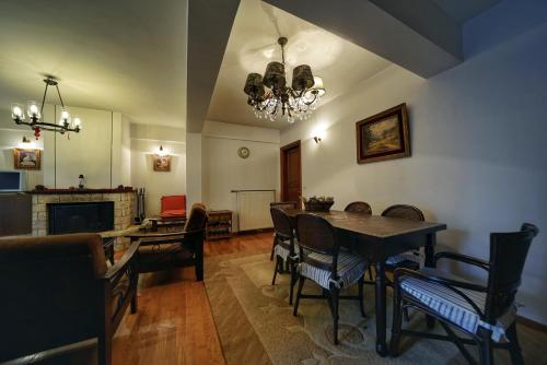 埃普塔罗弗斯Elatos Guest House的一间带桌椅和吊灯的用餐室