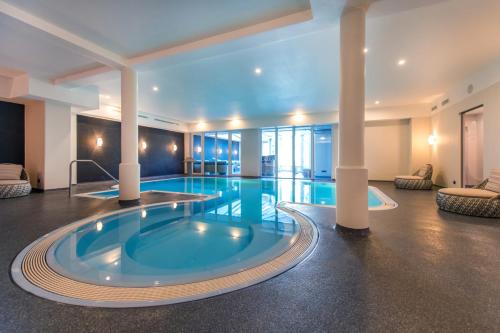 科赫姆莫斯罗曼蒂克凯斯勒迈耶酒店的游泳池位于酒店带热水浴池的客房