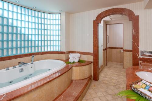 埃拉特Herods Boutique Eilat a Premium collection by Fattal Hotels的带浴缸和盥洗盆的大浴室