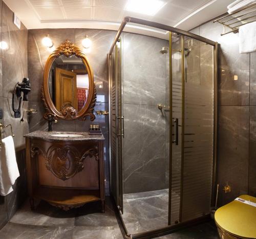 科尼亚Bablin Butik Otel的带淋浴、盥洗盆和镜子的浴室