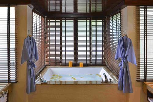 加亚岛Gaya Island Resort - Small Luxury Hotels of the World的一间带浴缸的浴室,位于带窗户的客房内