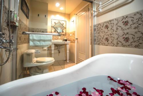 台中市伊丽莎白酒店的带浴缸和卫生间的浴室。