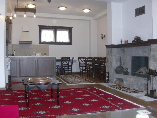 克鲁舍沃Casa La Kola Krusevo的客厅设有壁炉、桌子和椅子