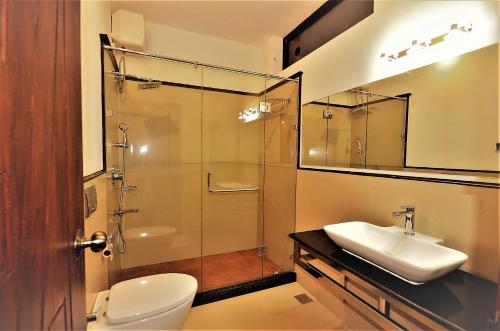 安巴拉瓦亚尔LakeRose Wayanad Resort的浴室配有卫生间、盥洗盆和淋浴。