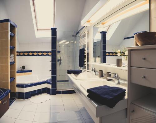 安纳贝格-伦格茨Postwirt Annaberg的浴室设有2个水槽、浴缸和浴缸。