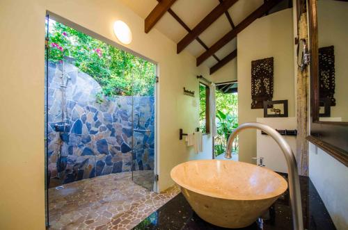 俊穆岛Koh Jum Beach Villas "A member of Secret Retreats"的浴室设有大型石质淋浴和木制浴缸。