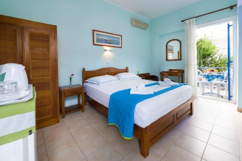 爱琴娜岛Electra的一间卧室配有一张带蓝色墙壁的大床