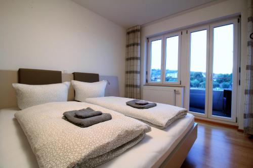 维尔茨堡Luxury city apartment - view of river and castle的一间卧室配有两张带毛巾的床