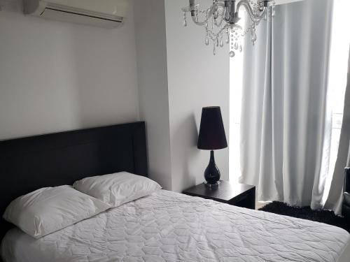 查梅Ibiza Playa Corona的一间卧室配有床、灯和窗户