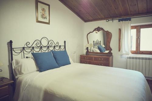 莱图尔Casa rural rincón de Letur的一间卧室配有一张大床和镜子