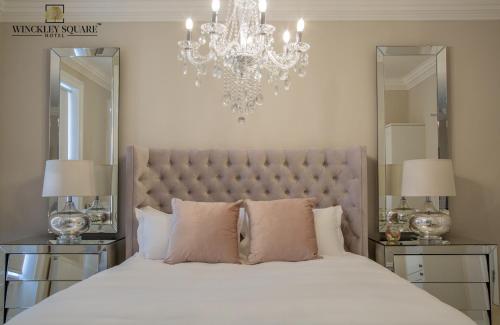 普雷斯顿Winckley Stays的卧室配有一张带吊灯的大型白色床。
