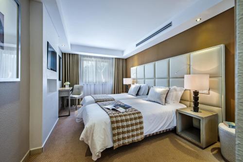 金塔湖Four Seasons Country Club的酒店客房设有一张大床和一张书桌。